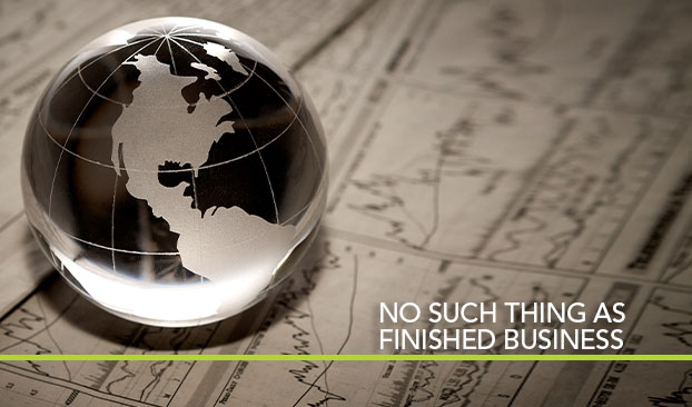 glass globe on investment paperwork, titled No Such Thing as Unfinished Business