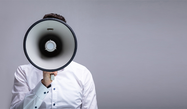 Business person with speaker phone hiding face